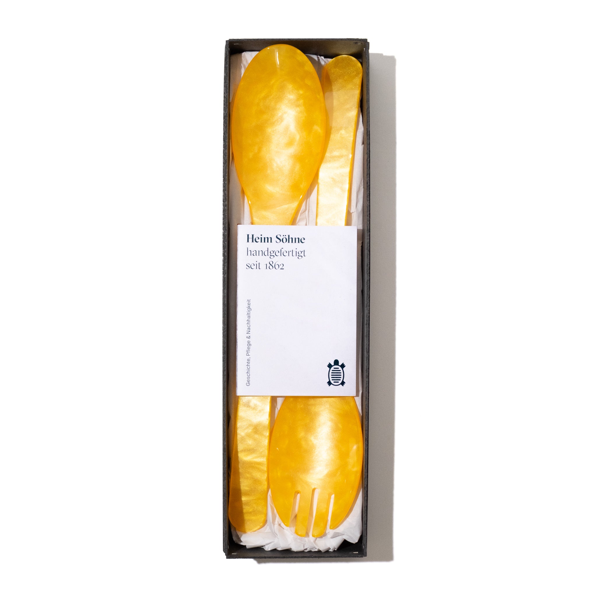Heim und Soehne Salatbesteck Sonnengelb in offener Verpackung